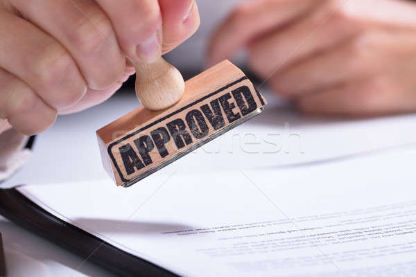 Person Hands Using Stamper On Document With The Text Approved Stock photo © AndreyPopov