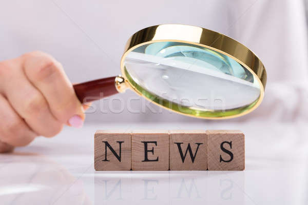 Businesswoman Examining News Cubic Blocks Stock photo © AndreyPopov