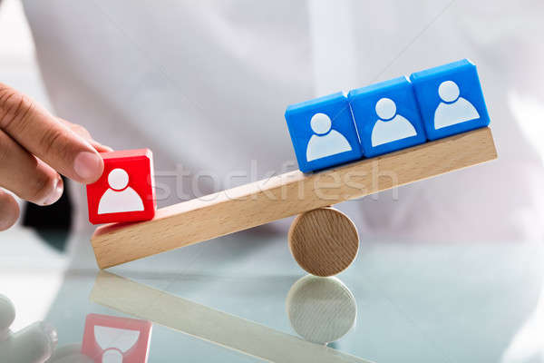 Person showing unbalance between single red and blue blocks Stock photo © AndreyPopov