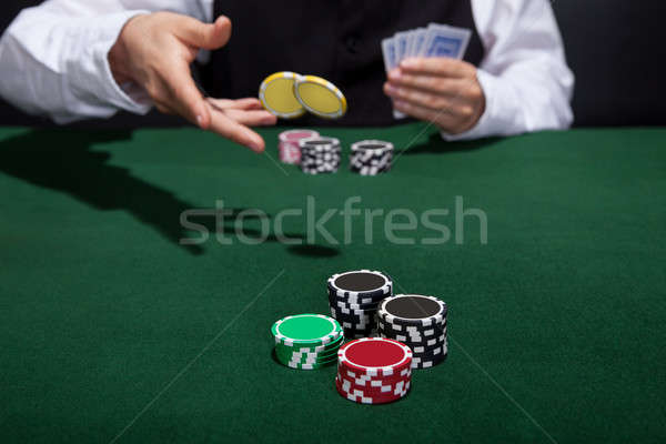 Poker player increasing his stakes Stock photo © AndreyPopov