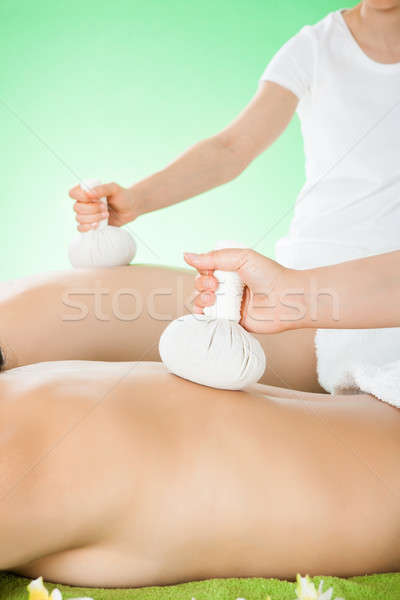 Couple Receiving Massage With Herbal Compress Stamps At Spa Stock photo © AndreyPopov