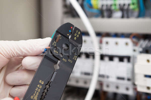 Male Electrical Engineer Cutting Cable Stock photo © AndreyPopov