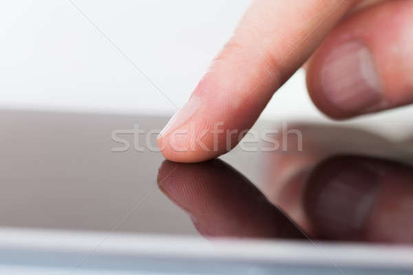 Businessman Touching Digital Tablet's Screen At Desk Stock photo © AndreyPopov