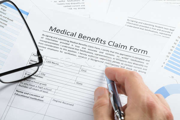Hand With Pen Over Medical Claim Application Stock photo © AndreyPopov