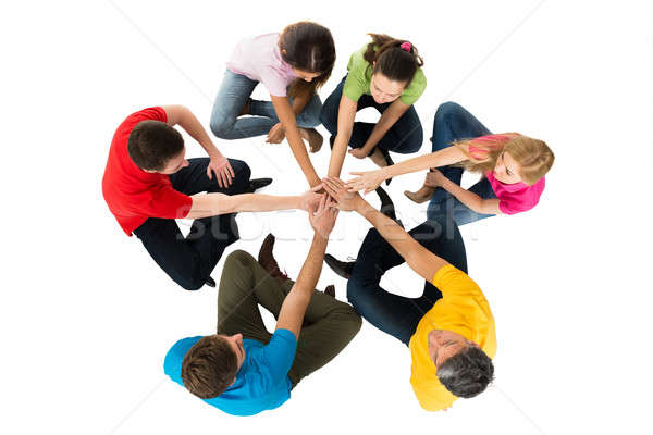 Friends Sitting In A Circle Stacking Hands Stock photo © AndreyPopov