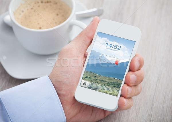 Hand Holding Mobile Phone With Low Battery Stock photo © AndreyPopov