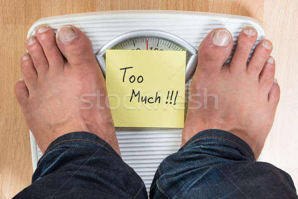 Man Standing On Weight Scale Stock photo © AndreyPopov