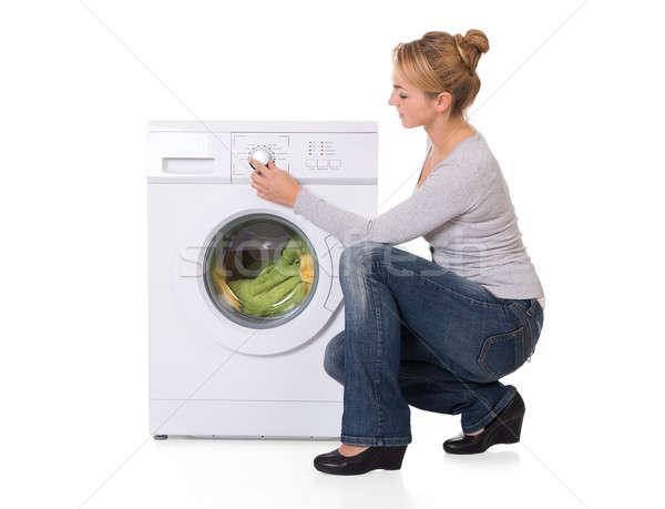 Nő guggol mosógép teljes alakos oldalnézet fiatal nő Stock fotó © AndreyPopov