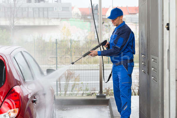Serviceman With High Pressure Water Jet Washing Car Stock photo © AndreyPopov