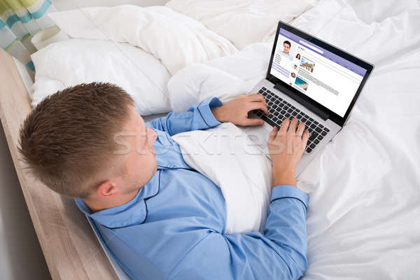 Man Chatting On Social Networking Site Stock photo © AndreyPopov