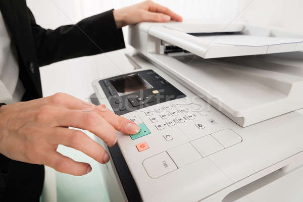 Businesswoman Hand Pressing Printer's Button Stock photo © AndreyPopov