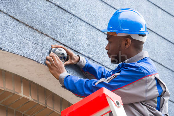 Technician Installing Camera On Wall Stock photo © AndreyPopov