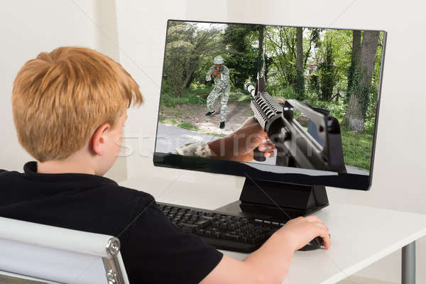 Boy Playing Action Game On Computer Stock photo © AndreyPopov
