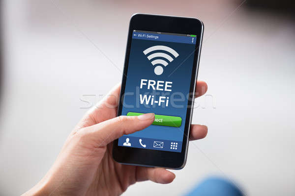 Person Connecting WiFi On Mobile Phone Stock photo © AndreyPopov