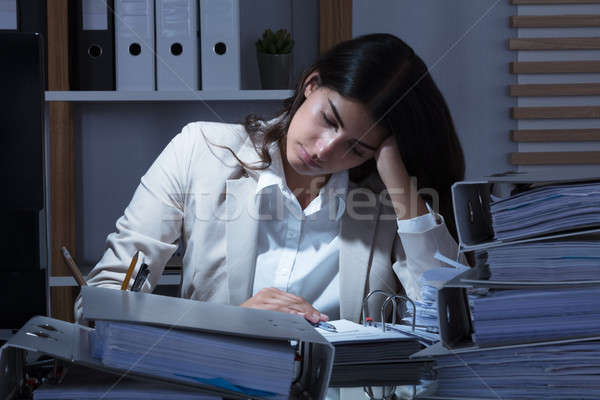 Businesswoman Working At Office With Stack Of Folders On Desk Stock photo © AndreyPopov
