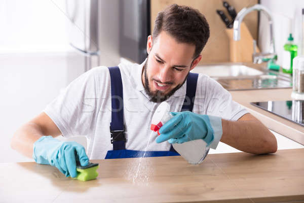 Man Cleaning Kitchen Worktop Stock photo © AndreyPopov