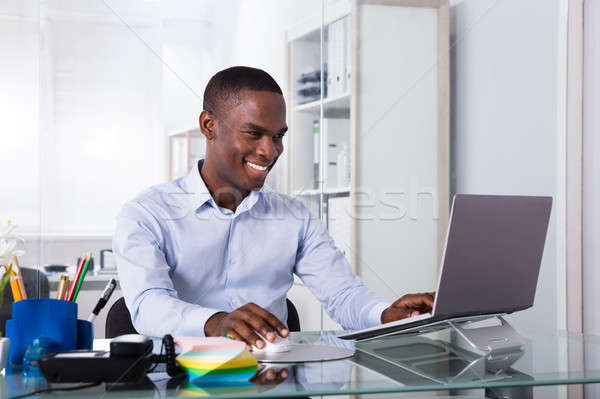 Smiling Businessman Using Laptop Stock photo © AndreyPopov