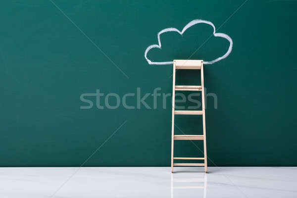 Wooden Ladder Leaning On Green Blackboard Stock photo © AndreyPopov