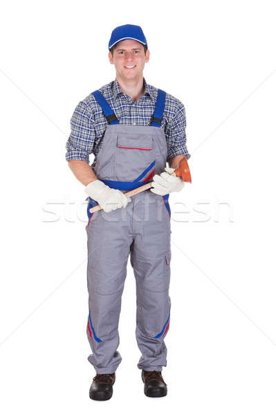 Happy plumber holding plunger Stock photo © AndreyPopov