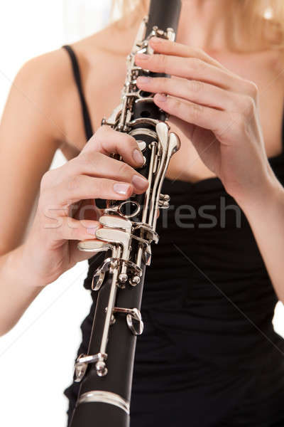 Beautiful young woman playing clarinet Stock photo © AndreyPopov