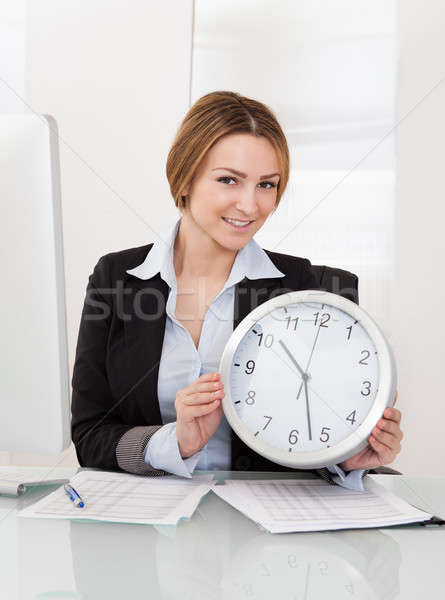 Businesswoman Holding Clock Stock photo © AndreyPopov