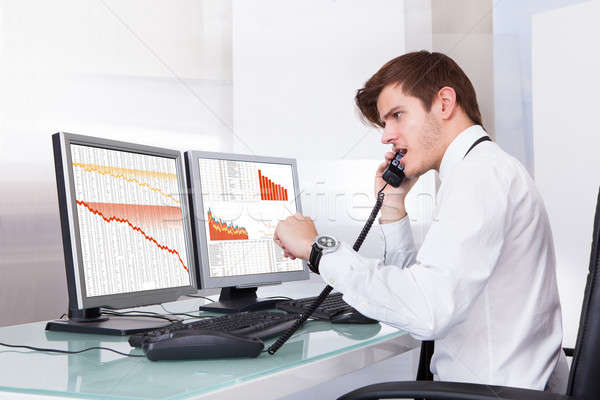 Frustrated Stock Broker Working At Office Stock photo © AndreyPopov