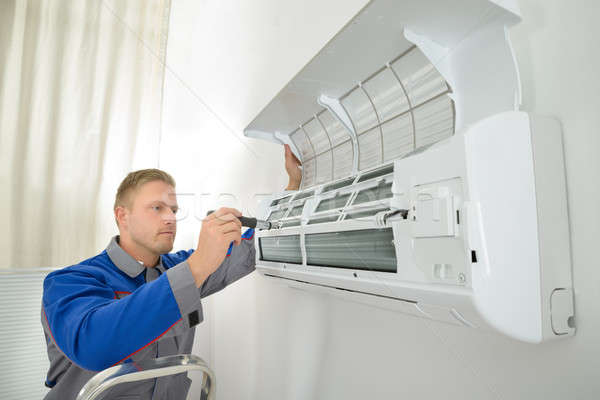 Repairer Repairing Air Conditioner Stock photo © AndreyPopov