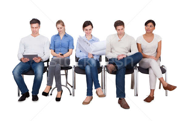 Businesspeople Doing Various Activities On Chairs Stock photo © AndreyPopov