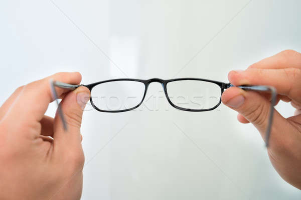 Hands Holding Eyeglasses Stock photo © AndreyPopov