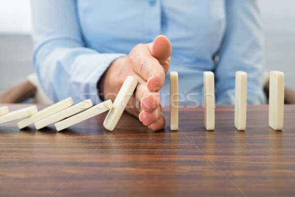 Businesswoman Stopping The Effect Of Domino Stock photo © AndreyPopov