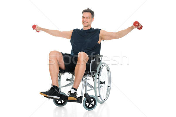 Behindert Mann Rollstuhl Hantel weiß Stock foto © AndreyPopov