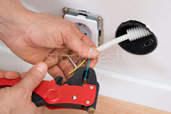 Stock photo: Electrician Peeling Insulation Of Wire