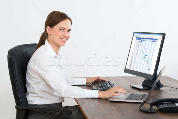 Businesswoman Working With Computer At Desk Stock photo © AndreyPopov