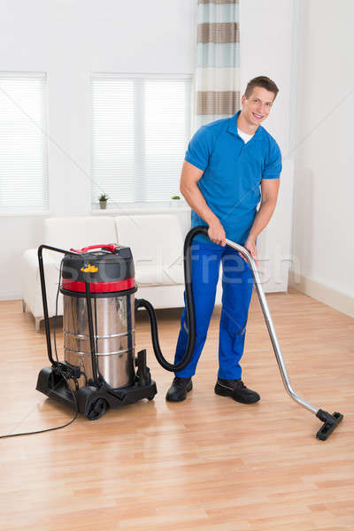 Male Janitor Vacuuming Floor Stock photo © AndreyPopov