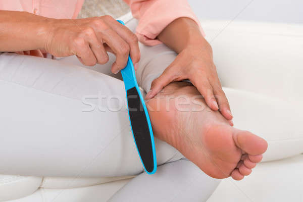 Close-up Of Woman Filing Foot Stock photo © AndreyPopov