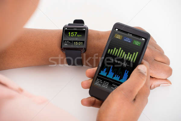 Hand With Mobile And Smartwatch Showing Heartbeat Rate Stock photo © AndreyPopov