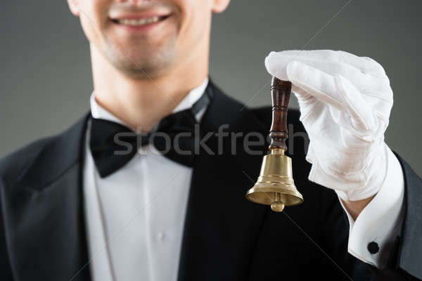 Midsection Of Waiter Holding Ring Bell Stock photo © AndreyPopov