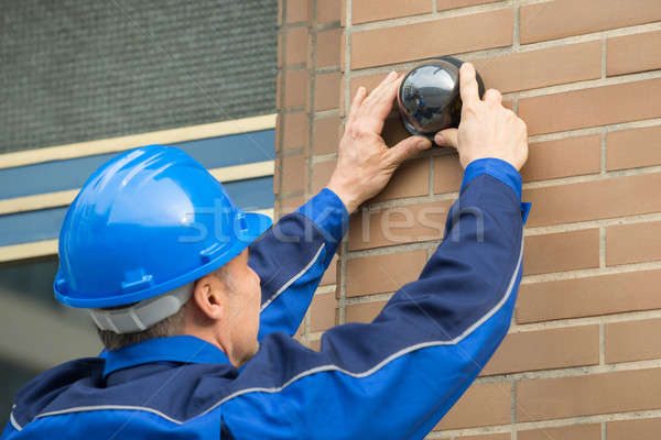 Close-up Of Technician Installing Camera In Building Stock photo © AndreyPopov