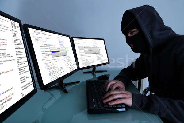 Hacker Stealing Data On Multiple Computers Stock photo © AndreyPopov