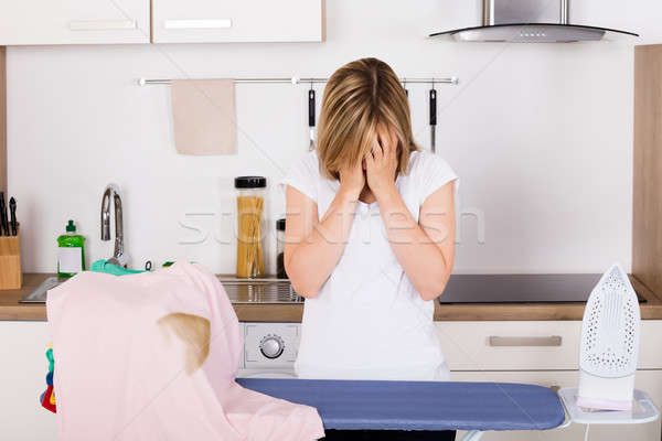 Shocked Woman Looking At Burnt T-shirt Stock photo © AndreyPopov