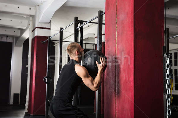 Male Athlete Doing Wall Balls Exercise Stock photo © AndreyPopov