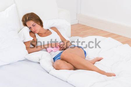 女性 ベッド お湯 袋 若い女性 腹 ストックフォト © AndreyPopov