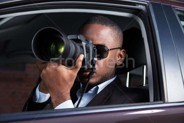 Detective Sitting Inside Car Photographing Stock photo © AndreyPopov