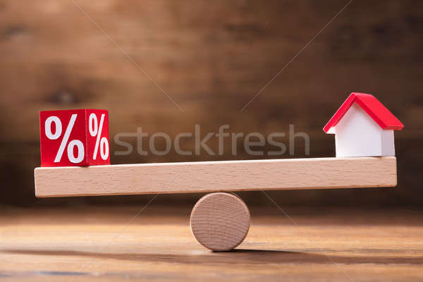 Balancing Of Percentage Red Block And House Model On Seesaw Stock photo © AndreyPopov