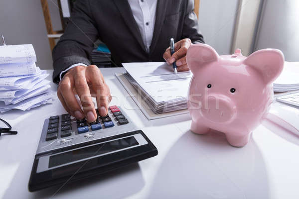 Businessperson Calculating Bill With Calculator Stock photo © AndreyPopov