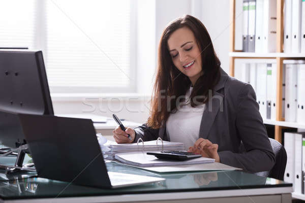 Happy Businesswoman Calculating Bill Stock photo © AndreyPopov