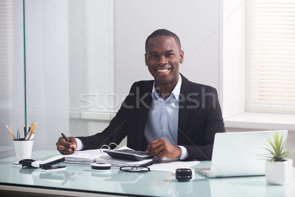 Smiling African Businessman Working At Workplace Stock photo © AndreyPopov