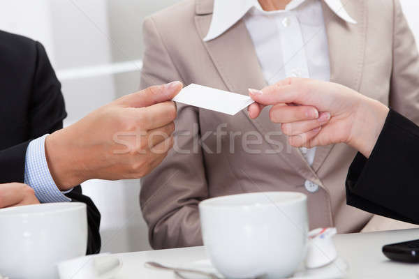 Businesspeople exchanging cards over coffee Stock photo © AndreyPopov
