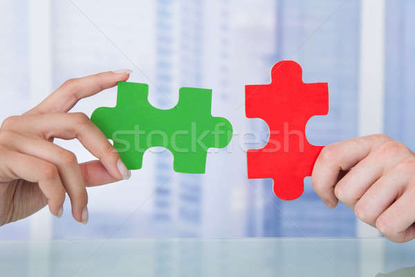 Business People Joining Jigsaw Pieces In Office Stock photo © AndreyPopov