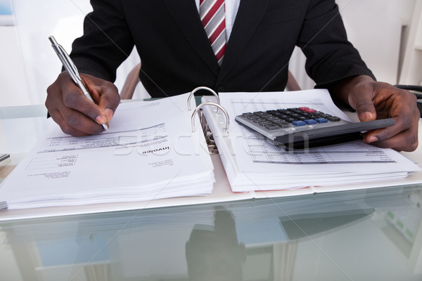 Businessman Doing Calculations Stock photo © AndreyPopov